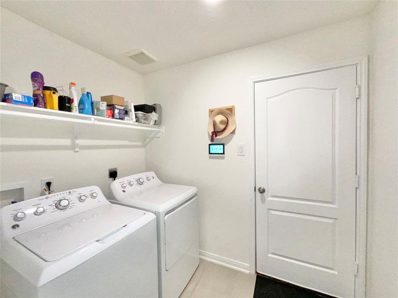 Laundry room inside of home leads to the garage.