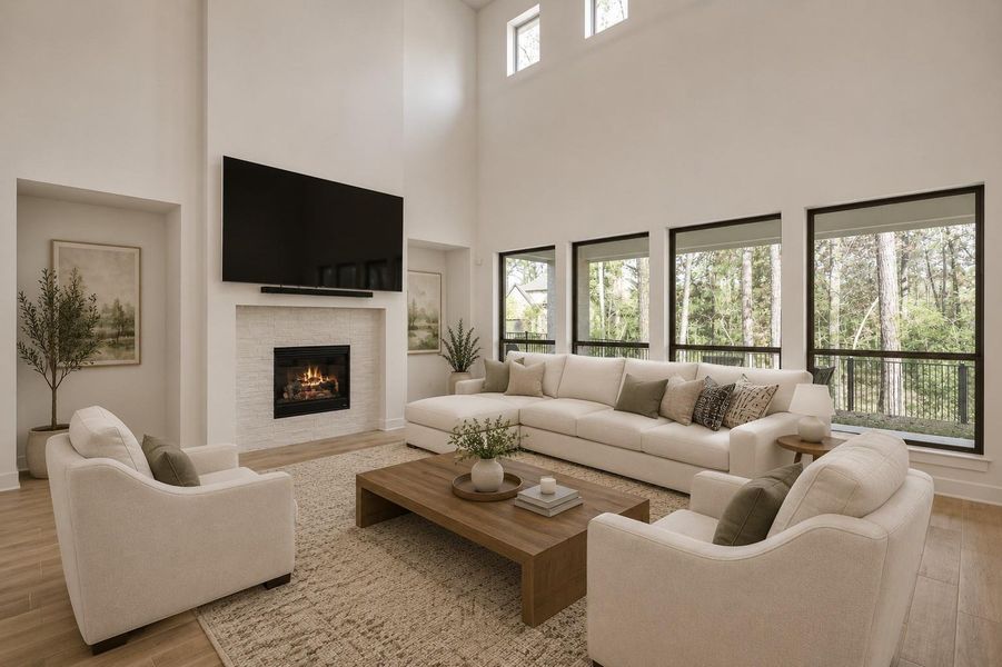 A cozy living space with a fireplace complemented by stylish flooring and towering ceilings! A cozy living space with a fireplace complemented by stylish flooring and towering ceilings!