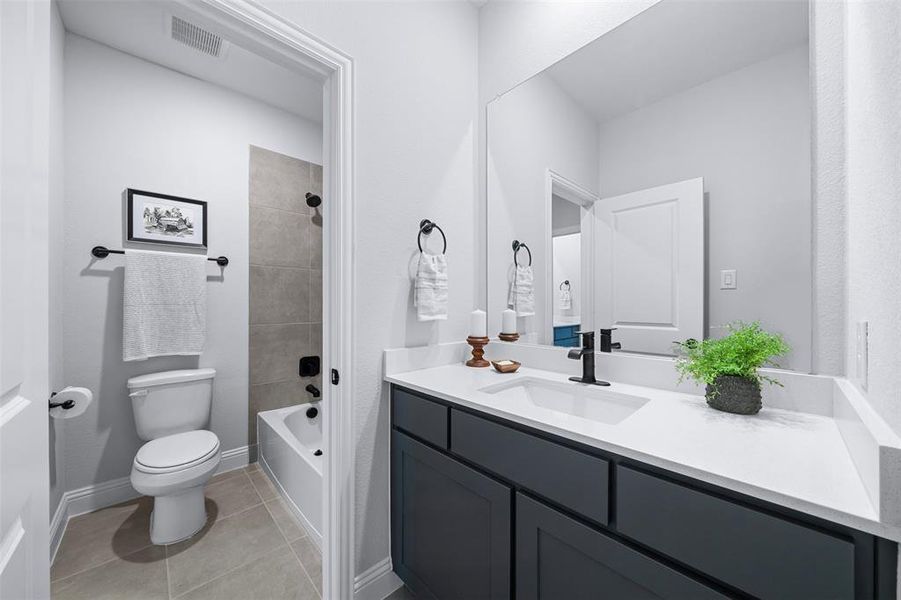 Bathroom with vanity, tile patterned flooring, and  shower combination