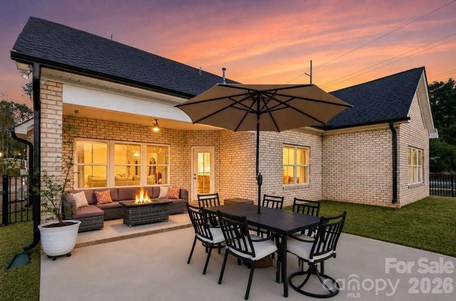 Covered patio with ceiling fan overlooking backyard!