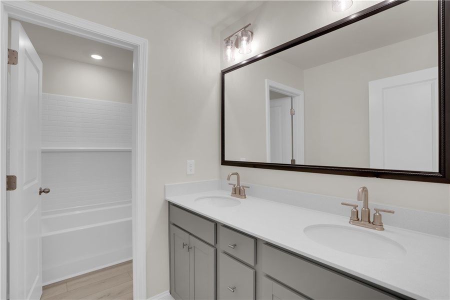 This bright bathroom features a spacious vanity an This bright bathroom features a spacious vanity an