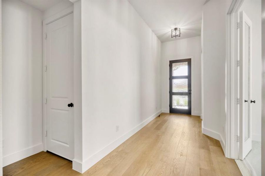 Foyer entrance with light wood-type flooring