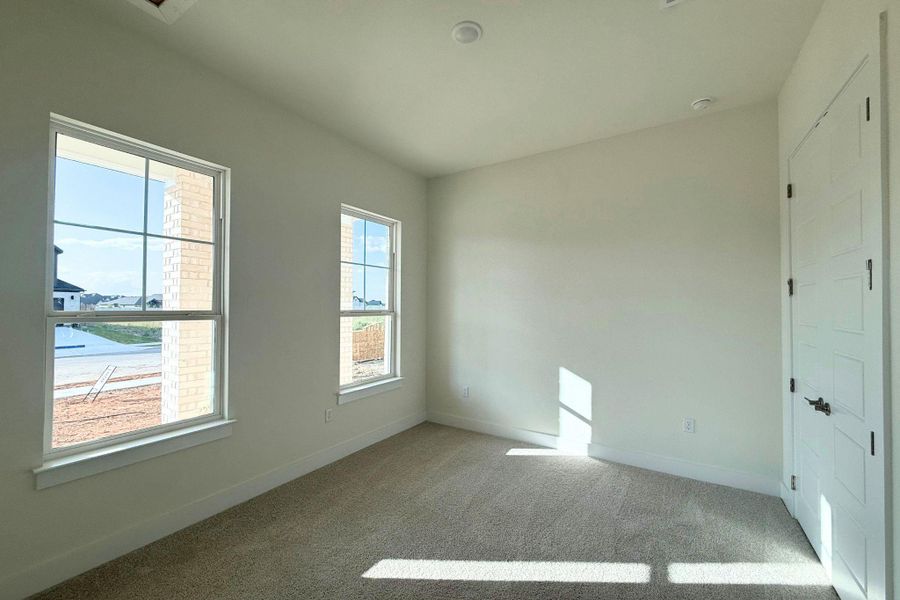 A quiet secondary bedroom with abundant light, ready for personal touches. A quiet secondary bedroom with abundant light, ready for personal touches.