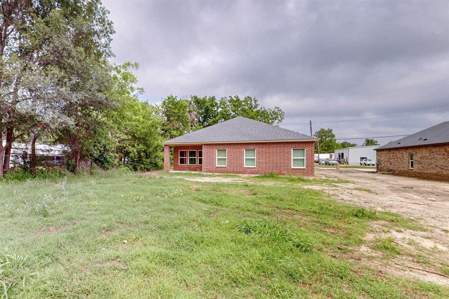 Back of house featuring a yard