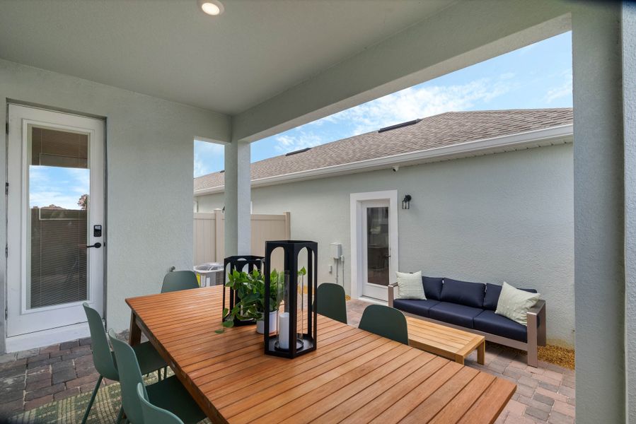 Exterior details and patio area of a home in Harvest at Ovation - Townhomes, Winter Garden (Image 22).