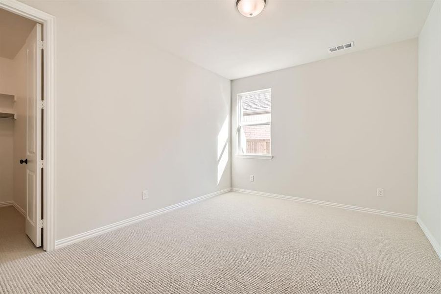 Unfurnished room featuring light colored carpet