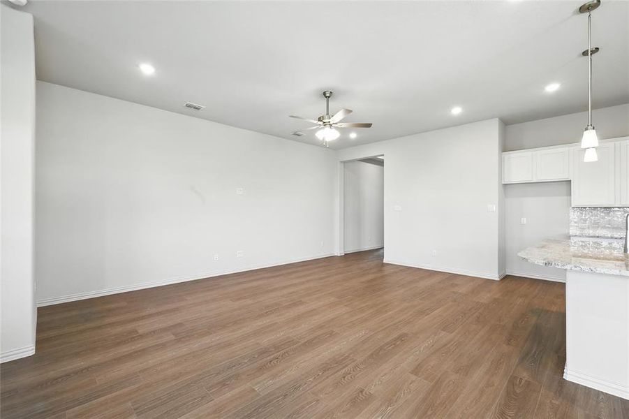 Unfurnished living room with recessed lighting, dark wood-style floors, and ceiling fan Unfurnished living room with recessed lighting, dark wood-style floors, and ceiling fan