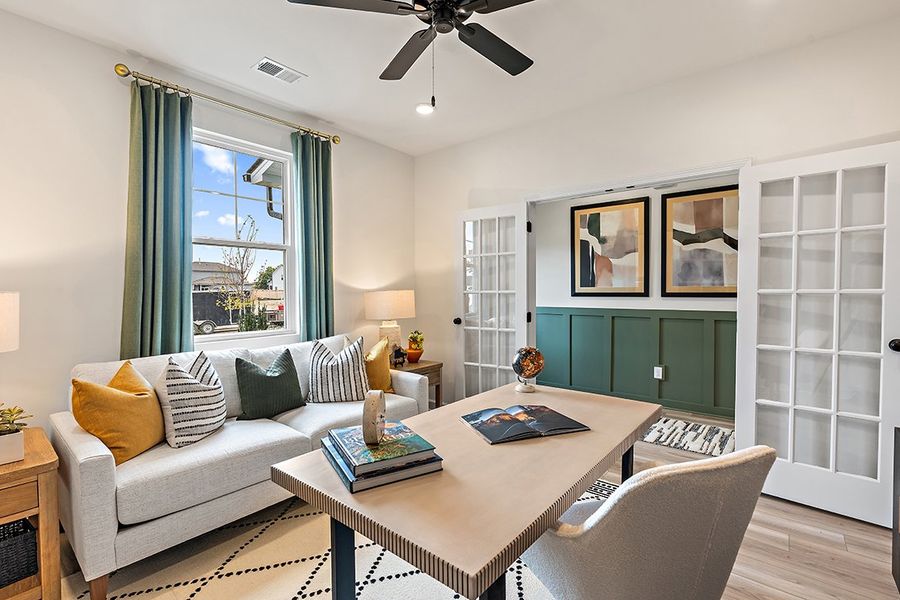 A living room with a couch and a table. A living room with a couch and a table.