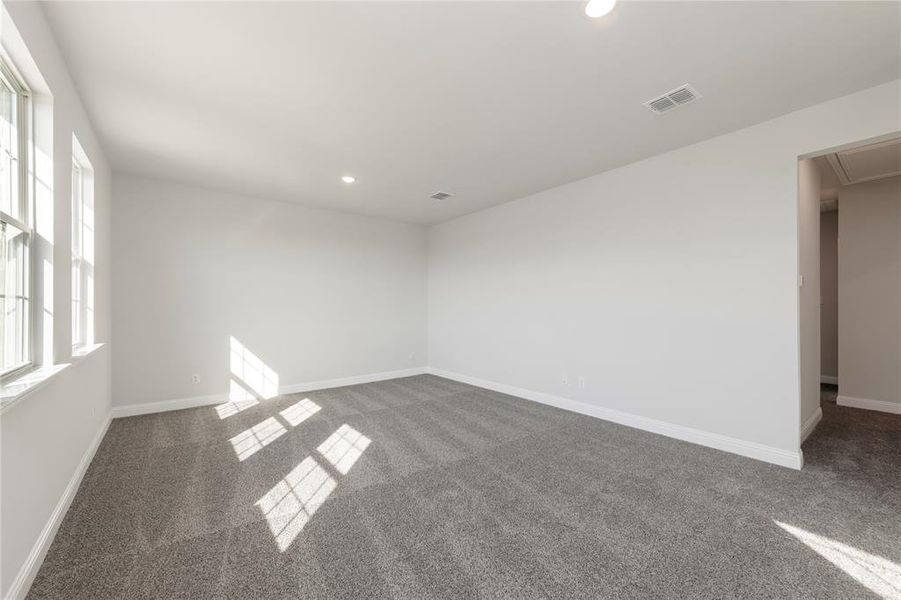 Carpeted empty room featuring recessed lighting, attic access, and baseboards Carpeted empty room featuring recessed lighting, attic access, and baseboards