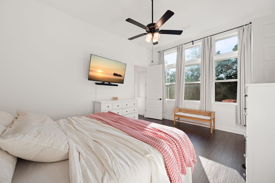 Natural light floods this inviting space, complete with rich dark hard surfaced floors and a modern ceiling fan. Natural light floods this inviting space, complete with rich dark hard surfaced floors and a modern ceiling fan.