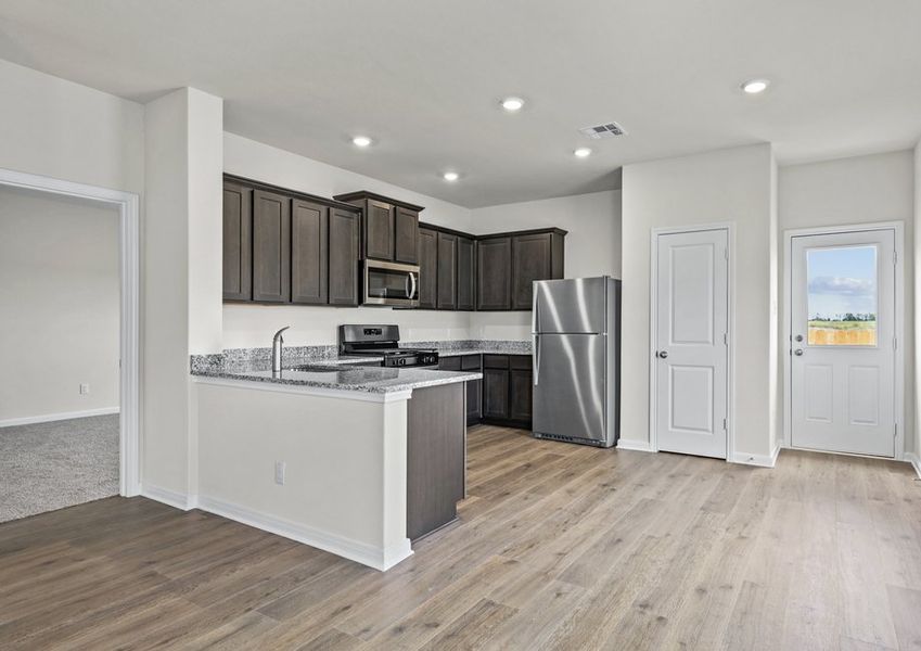 The kitchen has designer wood cabinetry.