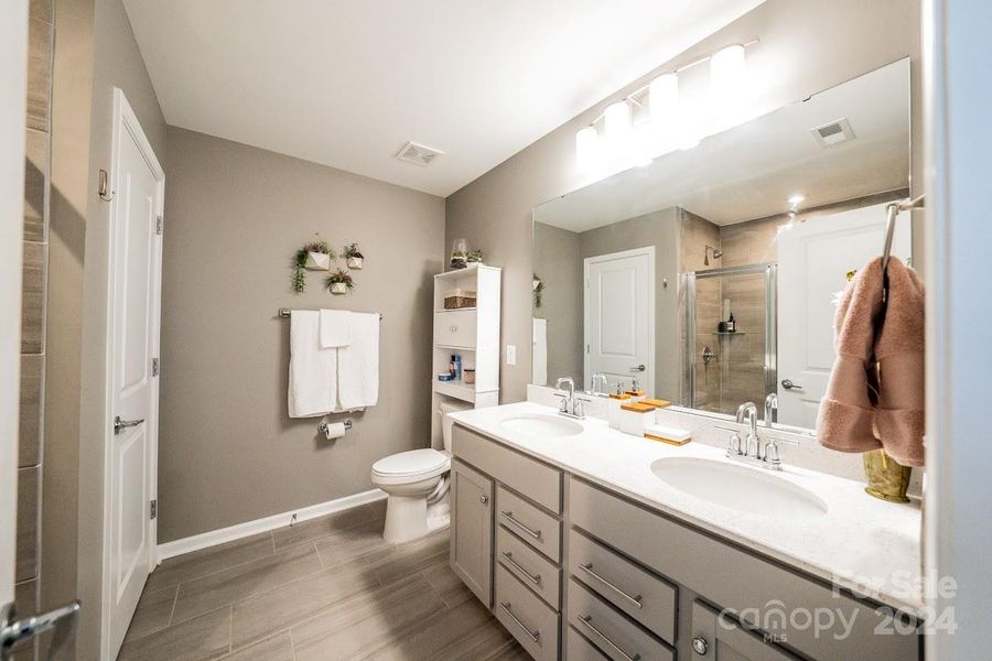 Double vanity sinks with lots of storage under the counter and  in the closet that is designed just for your bathroom essentials