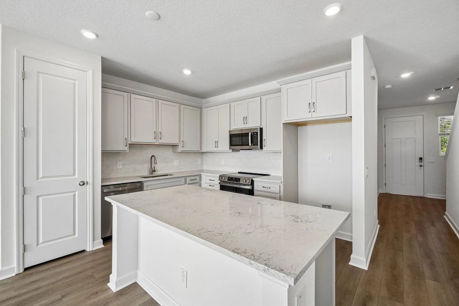 The kitchen featuring the AW Collection® Milan has a large island
