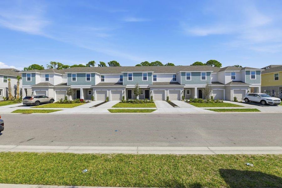 Front exterior of a new home in Vinterra Townhomes, Nokomis, FL, highlighting curb appeal (Image 19).
