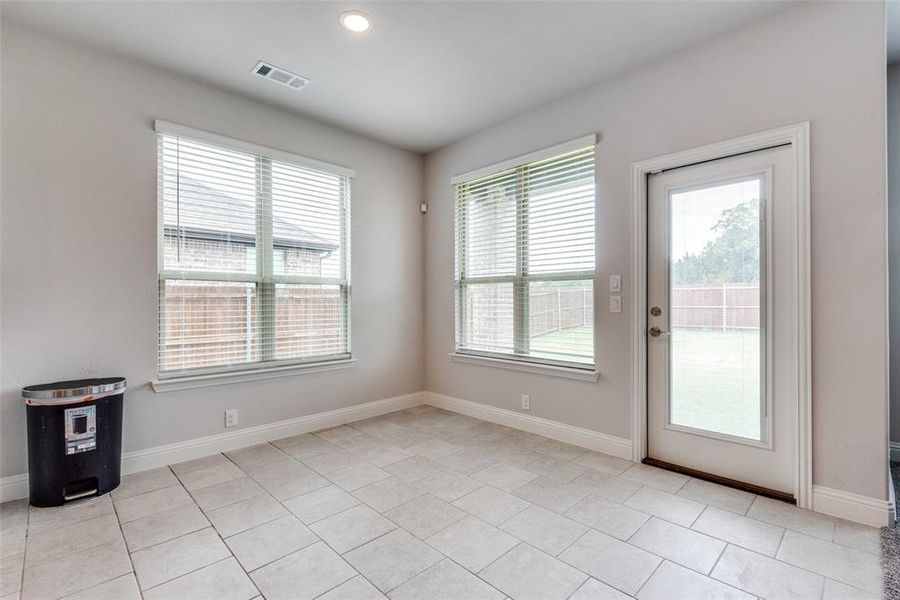 Entryway with light tile patterned flooring and a healthy amount of sunlight