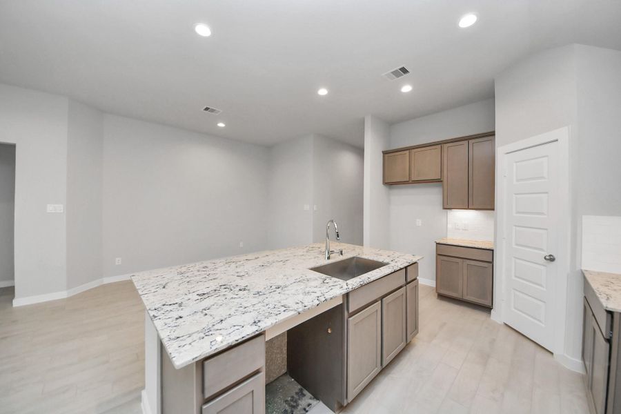 This generously spacious kitchen is a dream realized! Sample photo of completed home with similar floor plan. Actual colors and selections may vary.