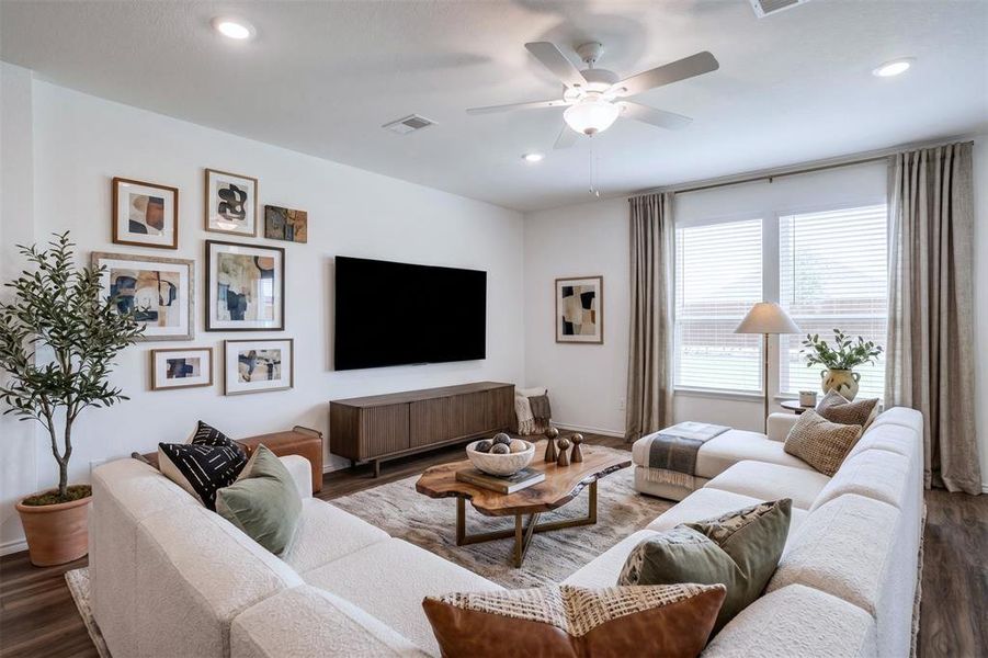 Spacious living area featuring wood-finish flooring, recessed lighting, and a ceiling fan