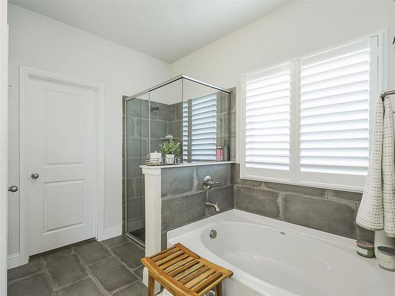 Bathroom featuring shower with separate bathtub