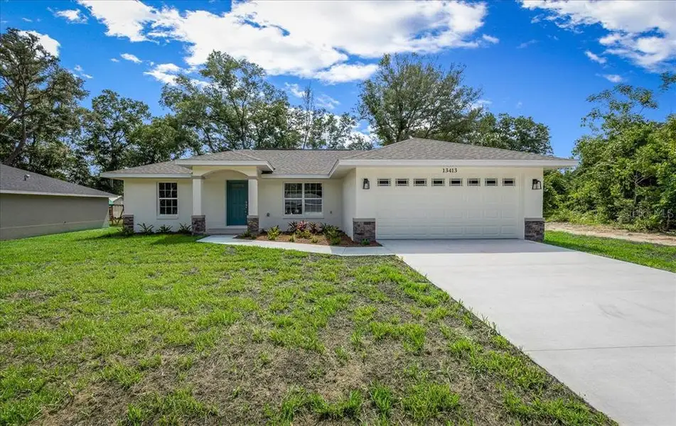 Front exterior of a new home in , Belleview, FL, highlighting curb appeal (Image 17).