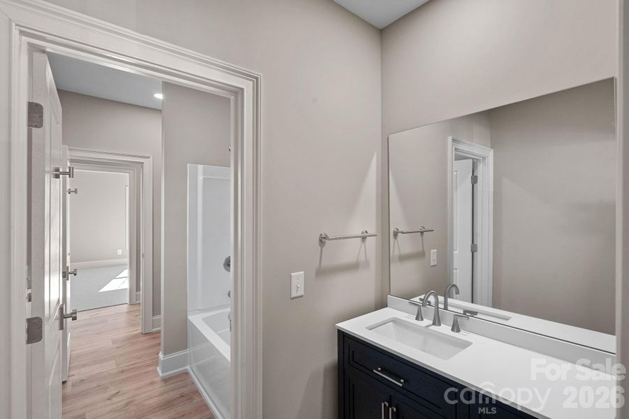Two of the secondary bedrooms on the upper level share a "Jack and Jill" style bathroom with dual vanities that is both beautiful and functional.