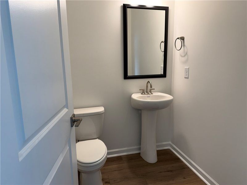 A well-appointed powder room features a classic pe A well-appointed powder room features a classic pe