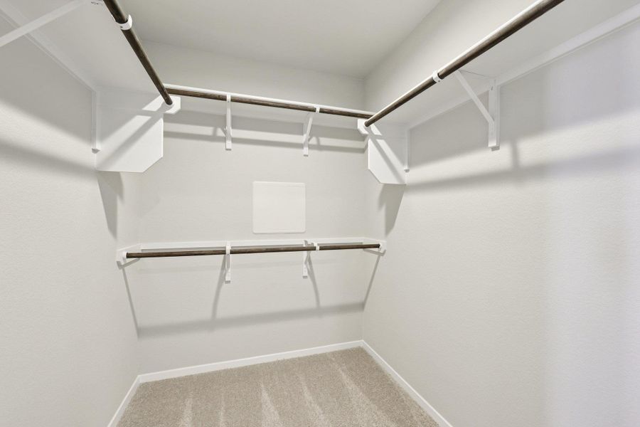 Walk-in closet in Primary Bedroom Walk-in closet in Primary Bedroom