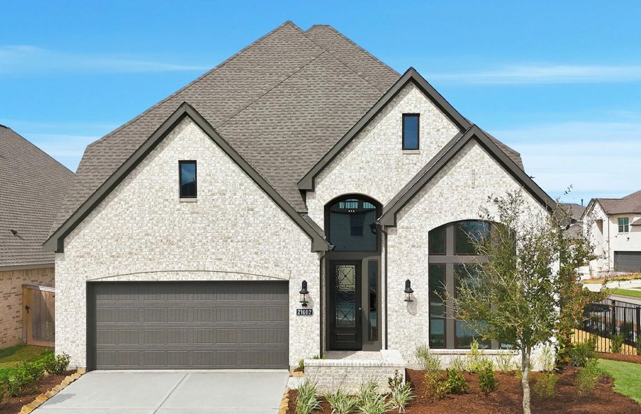 Front exterior of a new home in Bridgeland 50', Cypress, TX, highlighting curb appeal (Image 1). Front exterior of a new home in Bridgeland 50', Cypress, TX, highlighting curb appeal (Image 1).