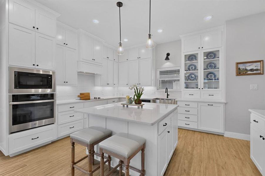 Stunning kitchen with massive island, apron sink built in microwave, oven and glass front hutch