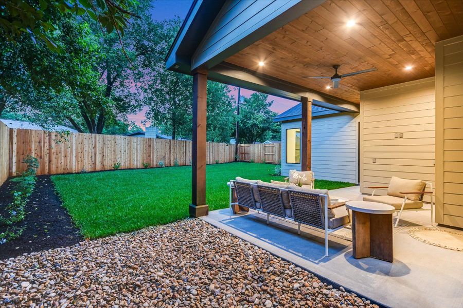 View from side yard to covered patio and private backyard beyond. View from side yard to covered patio and private backyard beyond.