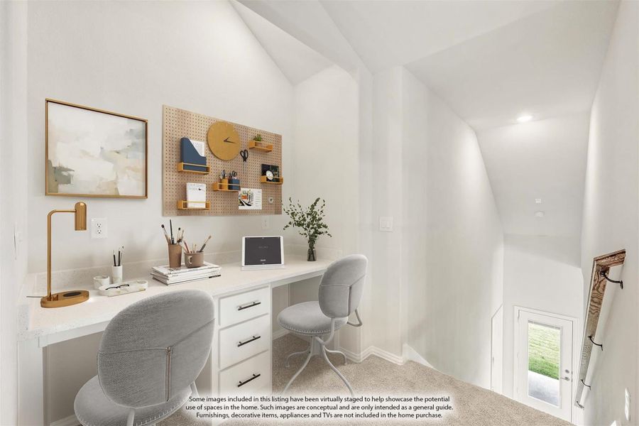 Home office nook with built-in white desk, pegboard organizer, and vaulted ceiling near staircase landing