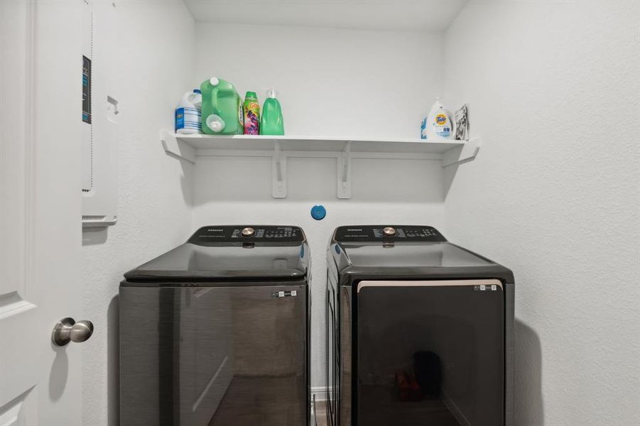 Spacious laundry room is conveniently located on the second floor near the bedrooms