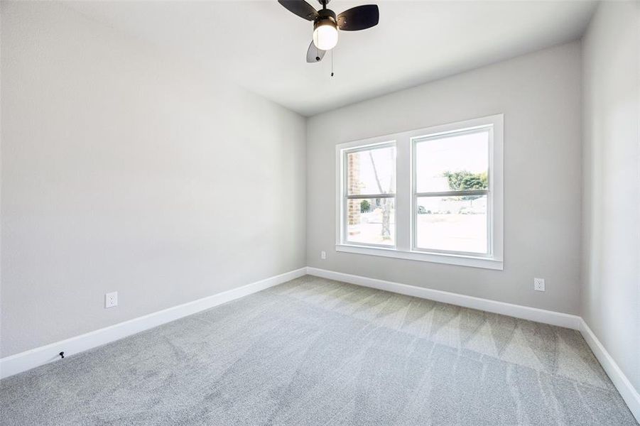 Empty room with light colored carpet and ceiling fan Empty room with light colored carpet and ceiling fan
