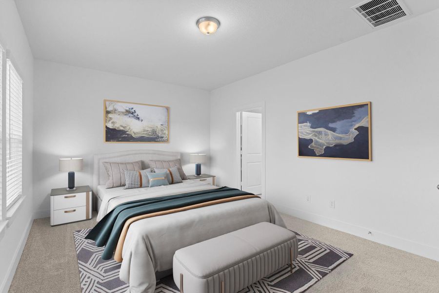 The spacious primary suite offers a calm and cozy retreat with soft carpet, large windows, and plenty of natural light. It’s the perfect place to relax and unwind after a long day.