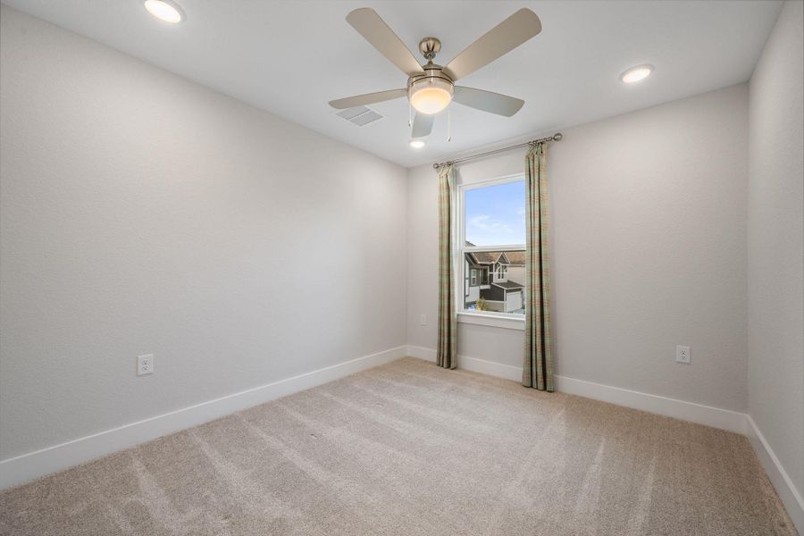 The 2nd bedroom with custom curtain and celling fan, and closet.