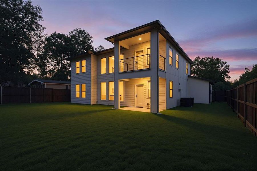 Back of property with a fenced backyard, a patio area, and a balcony Back of property with a fenced backyard, a patio area, and a balcony