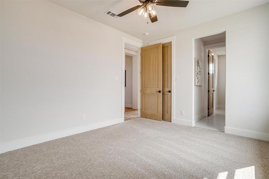 Unfurnished bedroom featuring carpet and ceiling fan