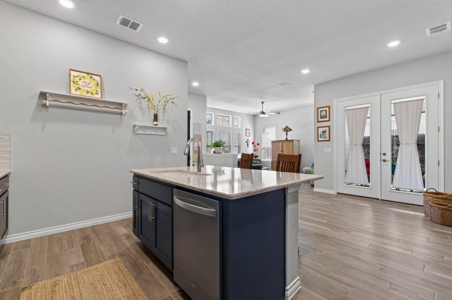 A sleek kitchen island with granite counters and stainless steel appliances flows into an inviting living area with natural light. A sleek kitchen island with granite counters and stainless steel appliances flows into an inviting living area with natural light.