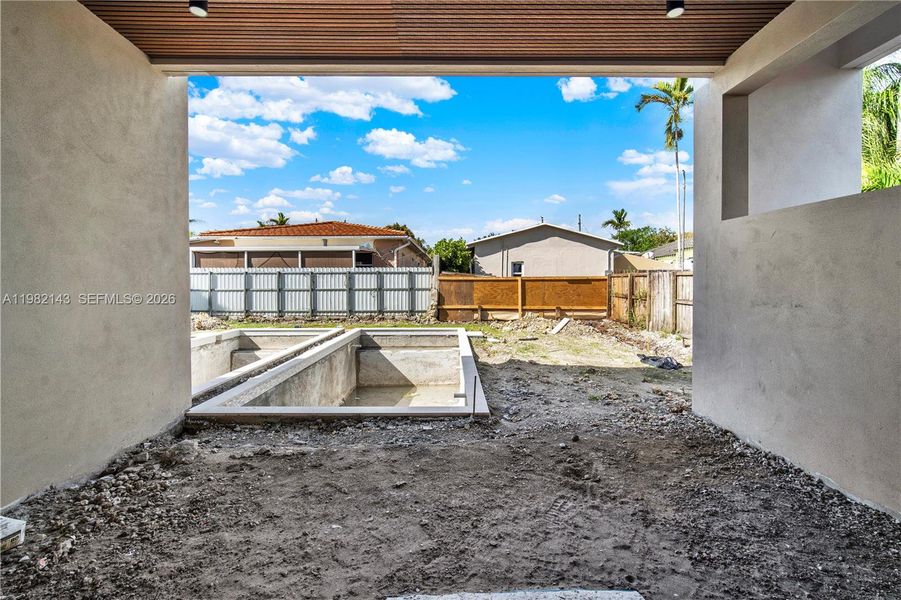 Covered patio with pool view. Covered patio with pool view.
