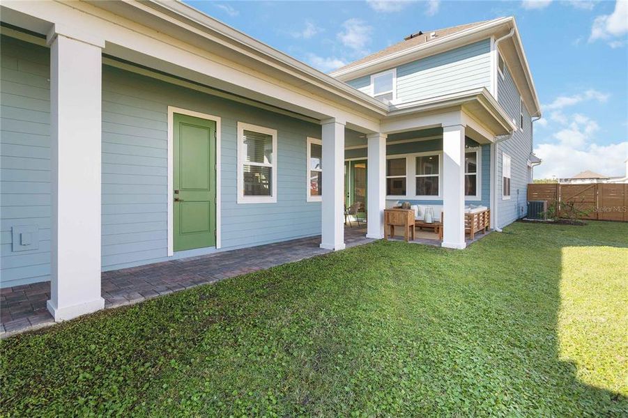 Exterior details and patio area of a home in Weslyn Park at Sunbridge (Craft Homes), St. Cloud (Image 28).