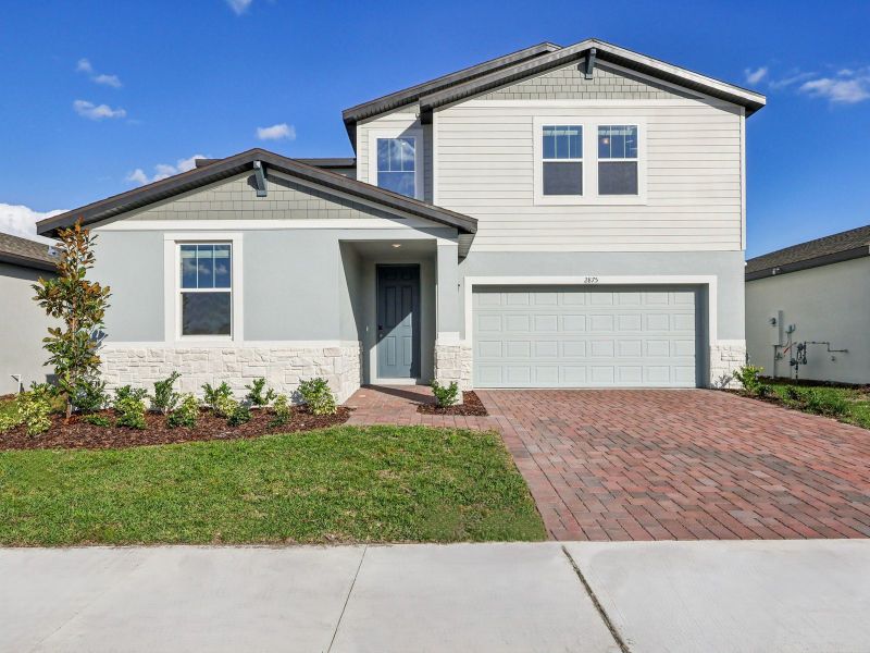 Front exterior of a new home in The Reserve at Twin Lakes, St. Cloud, FL, highlighting curb appeal (Image 1). Front exterior of a new home in The Reserve at Twin Lakes, St. Cloud, FL, highlighting curb appeal (Image 1).