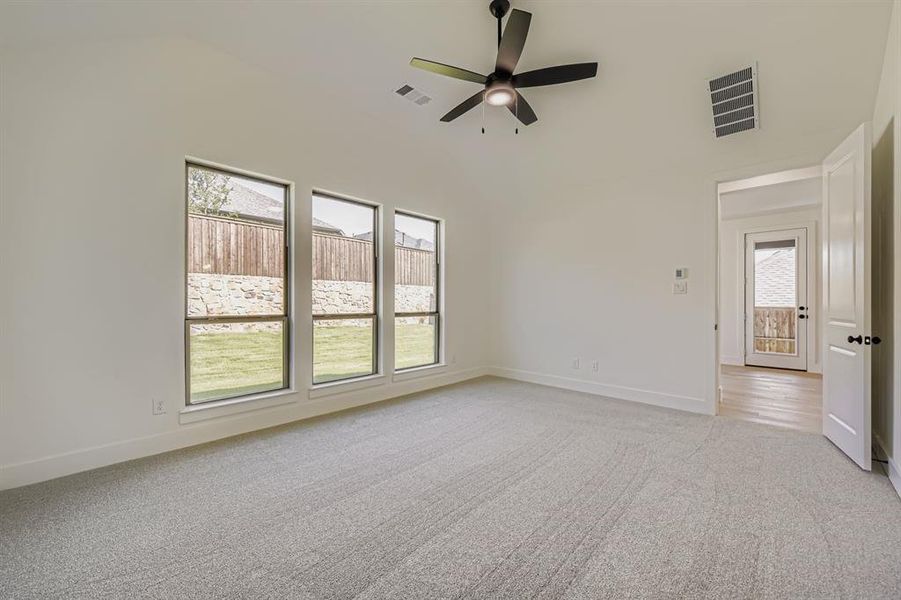 Spare room with light colored carpet and ceiling fan