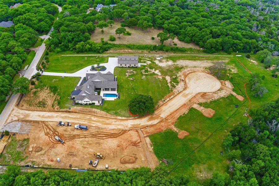 Expansive property featuring a contemporary residence, a detached auxiliary building, a rectangular swimming pool, and a large cul-de-sac development site Expansive property featuring a contemporary residence, a detached auxiliary building, a rectangular swimming pool, and a large cul-de-sac development site