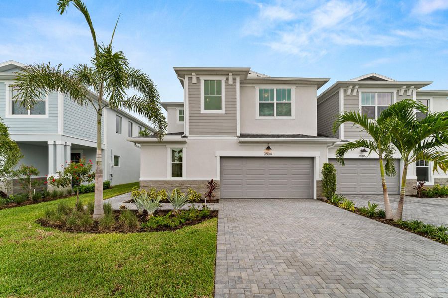 Front exterior of a new home in Avila, Jensen Beach, FL, highlighting curb appeal (Image 2).