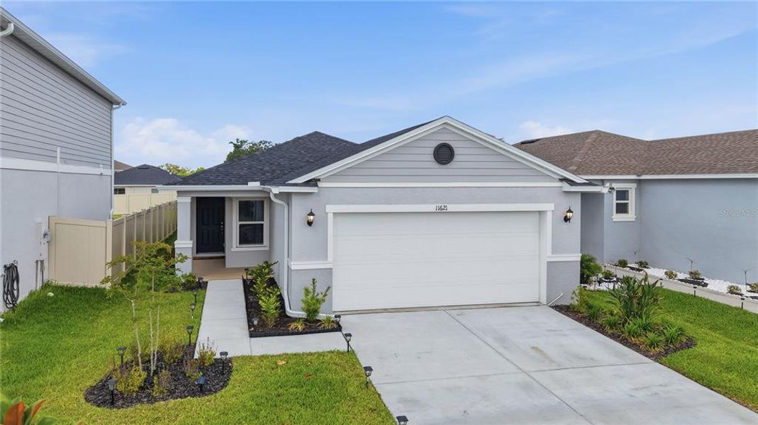 Front exterior of a new home in Magnolia Creek, Riverview, FL, highlighting curb appeal (Image 2). Front exterior of a new home in Magnolia Creek, Riverview, FL, highlighting curb appeal (Image 2).