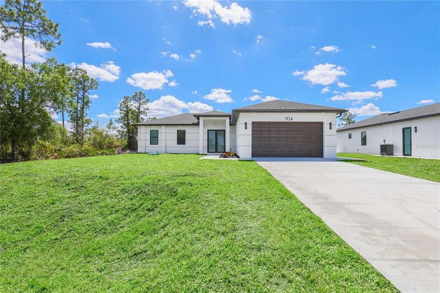 Front exterior of a new home in , Lehigh Acres, FL, highlighting curb appeal (Image 1). Front exterior of a new home in , Lehigh Acres, FL, highlighting curb appeal (Image 1).