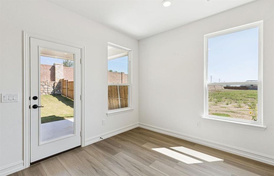 Dining nook off kitchen with large windows Dining nook off kitchen with large windows