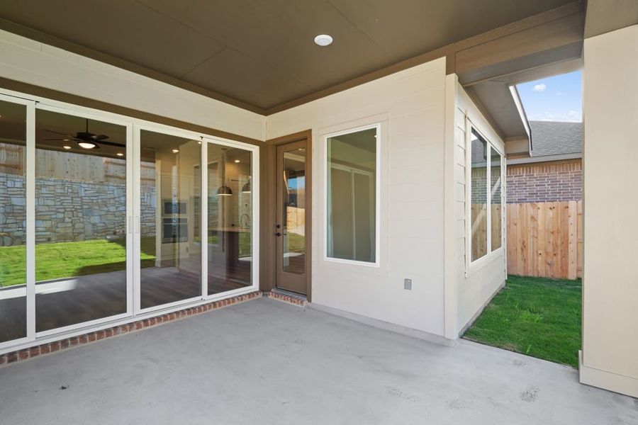 Exterior details and patio area of a home in Park Collection at Lariat, Liberty Hill (Image 23).