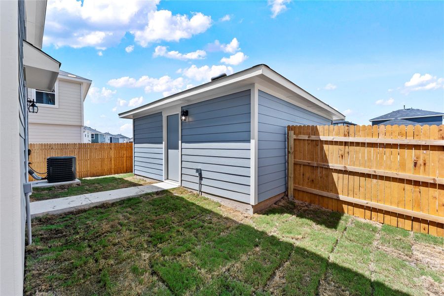 Exterior details and patio area of a home in Prairie Lakes, Buda (Image 13).