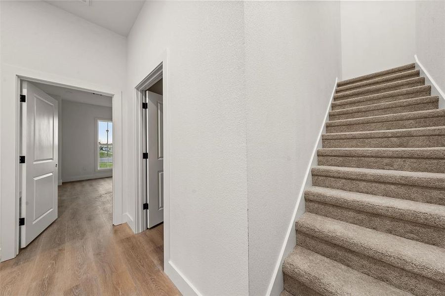 Stairs featuring baseboards and wood finished floors Stairs featuring baseboards and wood finished floors