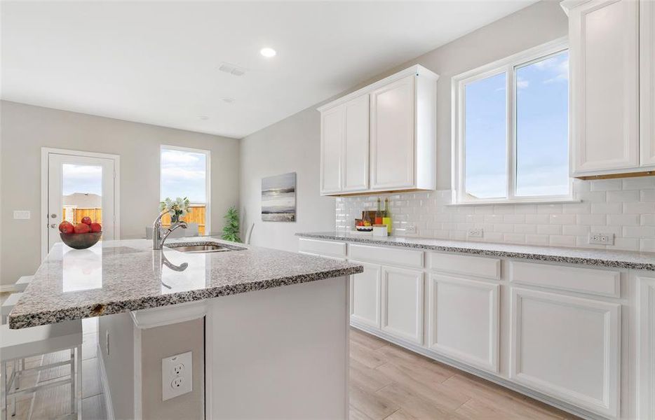 High-end gourmet kitchen with premium finishes and upgraded appliances *Model representation